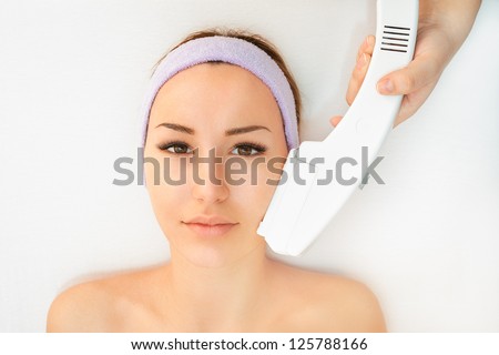 Woman receiving laser therapy Royalty-Free Stock Photo #125788166