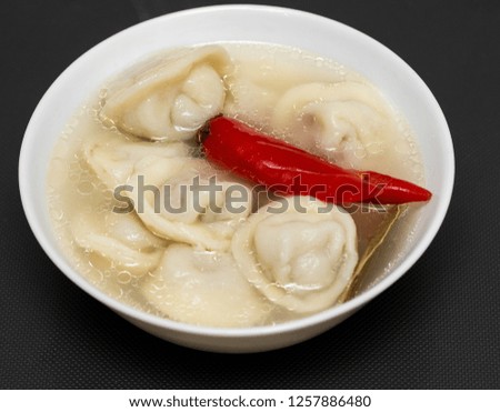 dumplings in a plate seasoning food on the table