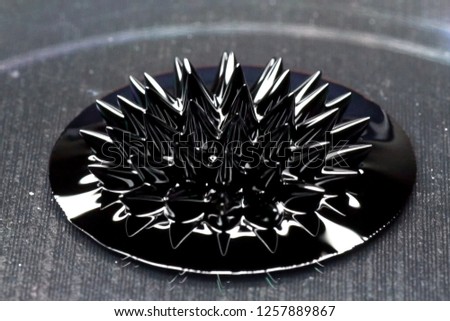 Beautiful forms of ferromagnetic fluid. Iron dissolved in a liquid under the influence of a magnetic field Royalty-Free Stock Photo #1257889867