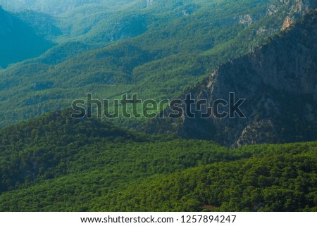Beautiful aerial view at green woody hills of mountains in Turkey. Hills with thick wood growing. Horizontal color photography.
