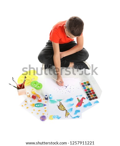 Cute child painting picture on white background