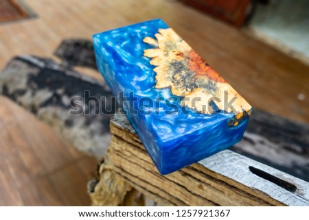 epoxy resin Stabilizing Afzelia burl exotic wood blue background, Abstract art picture photo, print design and your advertisement