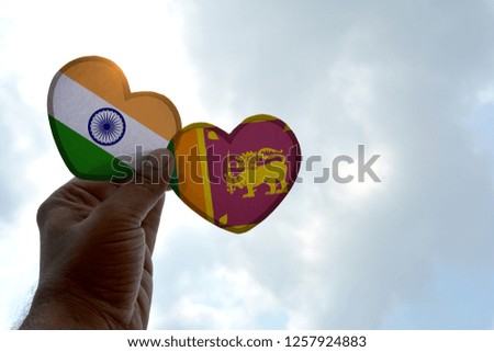 Hand holds a heart Shape India and Sri Lanka flag, love between two countries