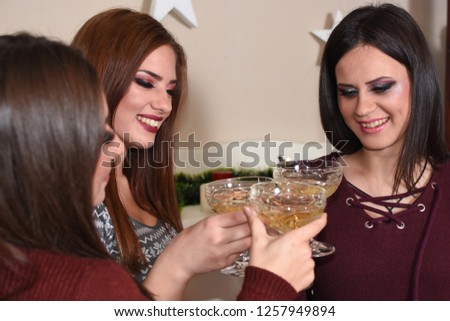 Three beautiful girls on the New Year's Eve. Best friends have new year party celebration