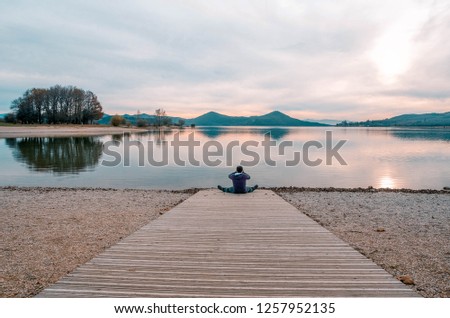 Man sitting taking pictures to the reservoir of Ullibarri-Gamboa. Alava, Basque Country, Spain