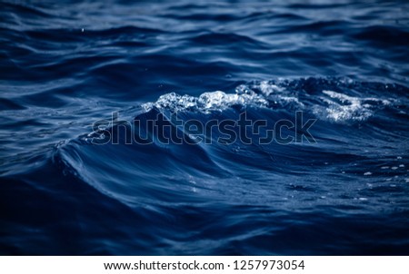 Trendy Phantom blue color. Aerial view of the sea surface background. Close up of water