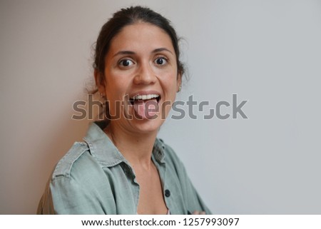 Portrait of comical relaxed young hispanic woman