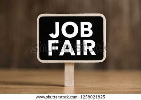 Job Fair text on blackboard sign board against wooden background.