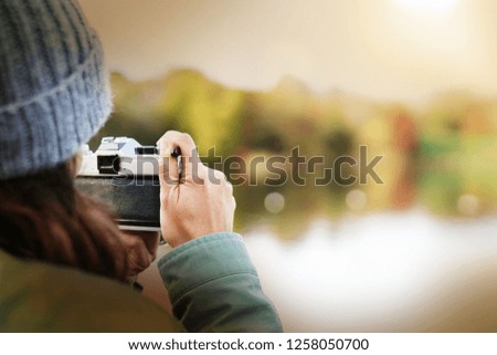 Close up of woman taking photos outdoors in fall