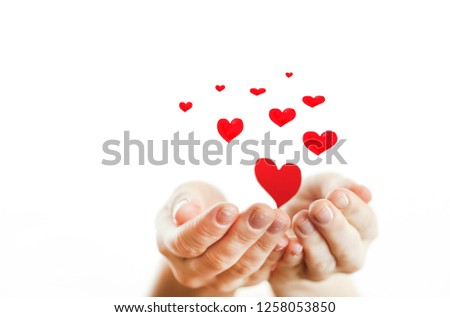 
Hands of a girl holding a red heart on a white isolated background. Concept of lovers day.