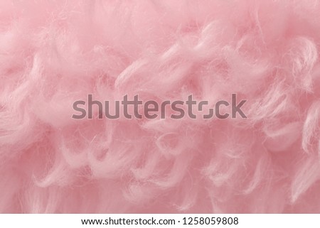 Pink animal wool texture background. Rosy tint natural wool. Close-up texture of  plush fluffy fur