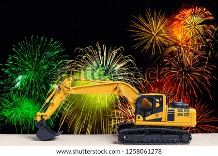 Excavator  model  with  on  fireworks backgrounds,New year festive celebration concept