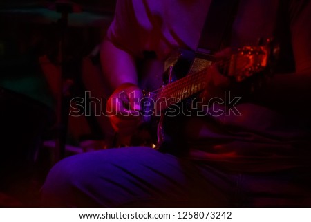 close up of man hand playing guitar.