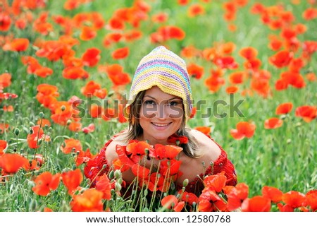 beautiful girl on a field with poppies