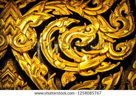 Closeup Thai pattern carving Lotus picture at door in temple