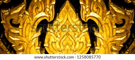 Closeup Thai pattern carving Lotus picture at door in temple