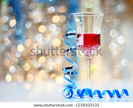Celebrating New Years with a glass of rose wine with twinkle lights in the background no people stock photo