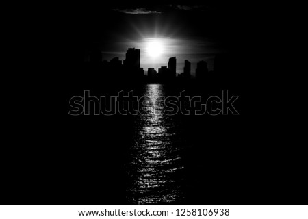 San Diego harsh cool skyline in monochrome black and white with beautiful contours of down town cityscape with burning sun reflecting in sea water. More similar content is found in my portfolio. 
