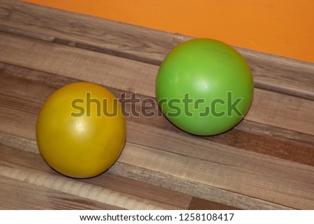 Sports balls for fitness of different sizes next to the mirror in the sports club
