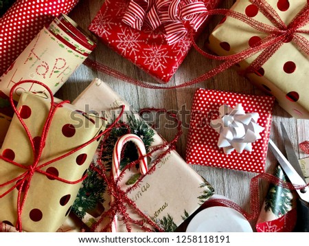 Christmas gifts with wrapping and ribbon on a rustic wooden surface