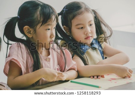 Little girls playing together at school or kindergarten. Concept for art and creative education. Kids hobby.