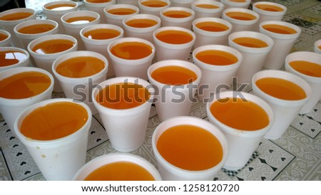 Disposable Glasses Filled With Orange Juice