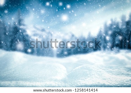 Snow on the background of the forest on Christmas evening with space for an advertising product 
