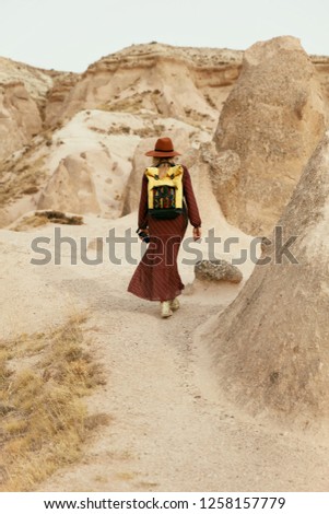Woman Traveling In Nature. Girl Traveler In Hat And Backpack