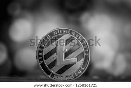 The silver litecoin. Altcoin on black table.