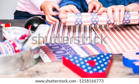 Step by step. Mother and daughter making paper firecrackers for July 4th celebration.