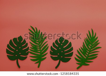 Trend coral summer background with palm leaves. Color of 2019. Flatlay concept. Horizontal shot.