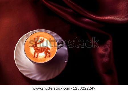 coffee cappuccino with cinnamon Christmas deer pattern on milk foam