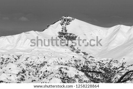 Black and white snowy winter mountains at sun evening. Caucasus Mountains, Shahdagh, Azerbaijan.