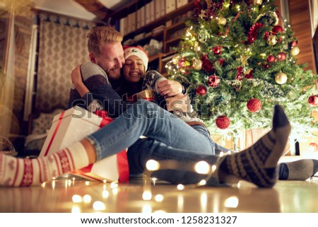 tradition gift for Christmas eve- romantic couple in love at Christmas night
