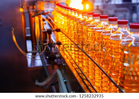 Sunflower oil. Factory line of production and filling of refined oil from sunflower seeds. Factory conveyor of food industry. Royalty-Free Stock Photo #1258232935