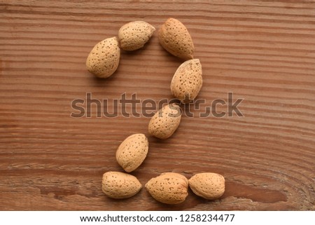a horizontal of the number 2 shaped with almonds Royalty-Free Stock Photo #1258234477