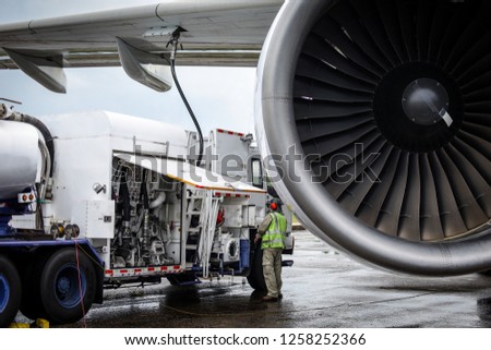 Aircraft refueling by high pressure fuel supply truck.Passenger jet airplane refuel from supply truck, airport service, refuel,Aircraft Refueling Hose. Royalty-Free Stock Photo #1258252366