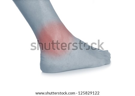 Acute pain in a woman ankle. Female holding hand to spot of ankle-ache. Concept photo with Color Enhanced blue skin with read spot indicating location of the pain. Isolation on a white background.