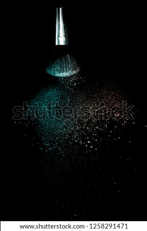 Living Coral and green ocean powder color splash and brush for makeup artist or graphic design in black background, look like a lively and joyful mood.