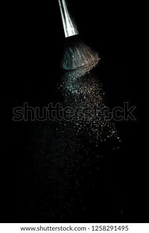 Living Coral and green ocean powder color splash and brush for makeup artist or graphic design in black background, look like a lively and joyful mood.