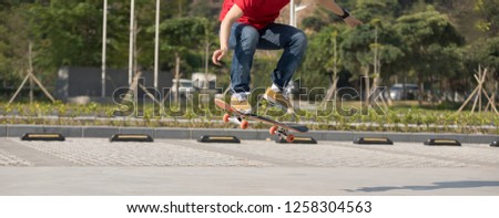 Skateboarder  skateboarding  on parking lot
