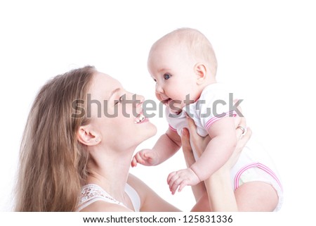picture of happy mother playing with sweet baby girl over white