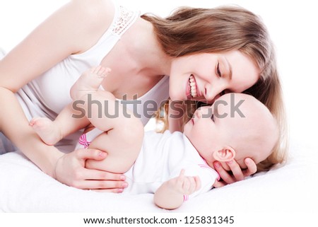 picture of happy mother playing with sweet baby girl over white