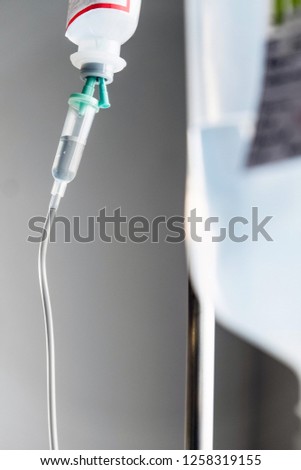 Close up of IV saline solution drip for patient in hospital 