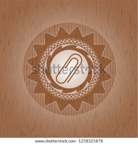 paper clip icon inside vintage wood emblem