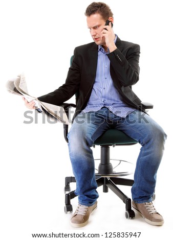 young businessman reads newspaper while phoning  job seeking white background