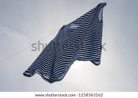 Drying of wet striped shirt.
