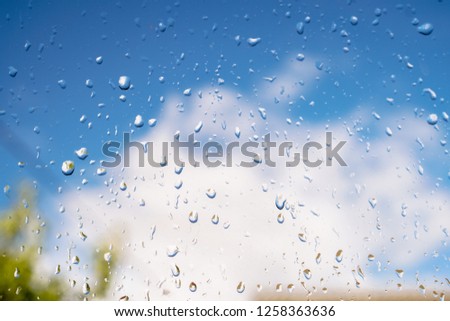 Beautiful raindrops on the window glass. Spring summer weather with warm rain. Stock photo