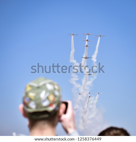 Man taking Photos of the Harvard( ex-air force trainers) 80th anniversary fly over at the Rand airshow in Johannesburg South Africa  