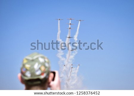 Man taking Photos of the Harvard( ex-air force trainers) 80th anniversary fly over at the Rand airshow in Johannesburg South Africa  